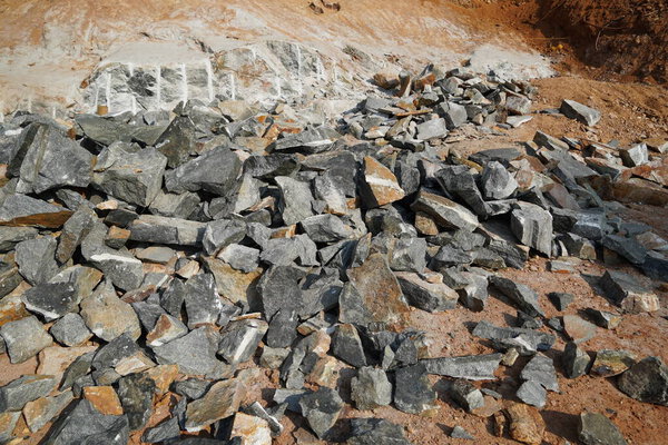 Pile Of Rocks I.E. Lithium Mining And Natural Resources Like Limestone Mining In Quarry. Natural Zeolite Rocks Are Excavated With Deforestation In Background.