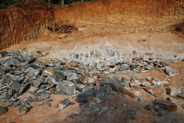 Pile Of Rocks I.E. Lithium Mining And Natural Resources Like Limestone Mining In Quarry. Natural Zeolite Rocks Are Excavated With Deforestation In Background.