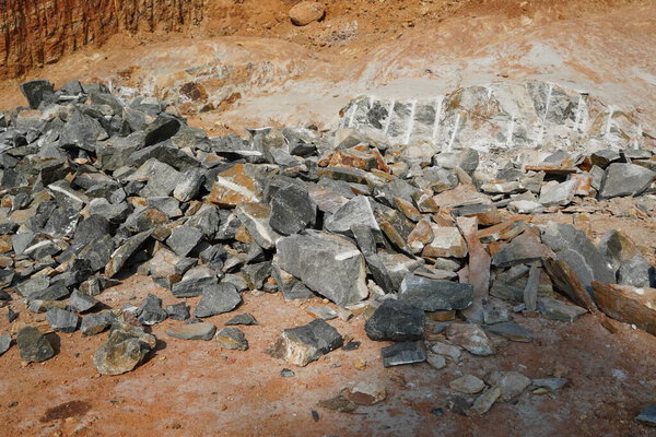 Pile Of Rocks I.E. Lithium Mining And Natural Resources Like Limestone Mining In Quarry. Natural Zeolite Rocks Are Excavated With Deforestation In Background.
