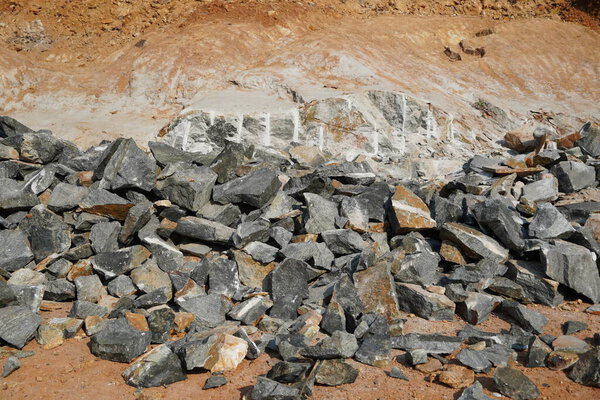 Pile Of Rocks I.E. Lithium Mining And Natural Resources Like Limestone Mining In Quarry. Natural Zeolite Rocks Are Excavated With Deforestation In Background.