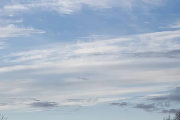 Blue sky with white and purple clouds and no horizon