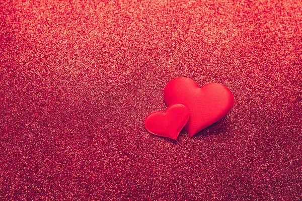 Due cuore rosso simbolo di amore su uno sfondo lucido. Concetto di San Valentino. Spazio di copia cornice orizzontale. — Foto Stock