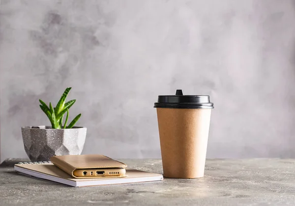 Disposable paper cup with a donut drink in chocolate icing candy truffles on a gray background. Creative levitation — 스톡 사진