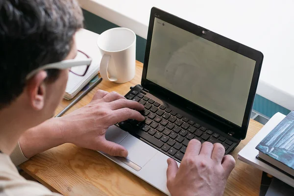 The concept of distance work or online learning during the quarantine virus. Young man working on digital laptop at home