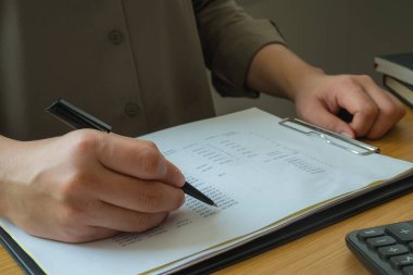 Bank employees sit and work and check the financial summary