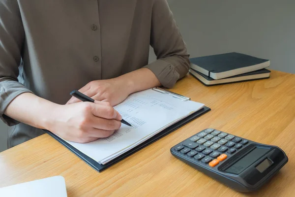 Bank employees sit and work and check the financial summary