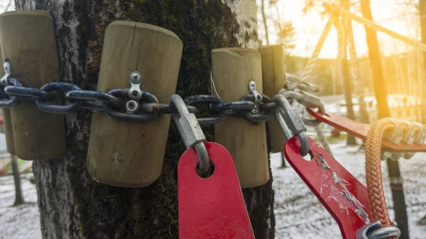 Close up of red rope and metal clips used for suspension bridge to the rope Park