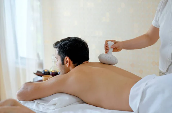 Handsome Man Enjoying Massage Herbal Ball His Back Spa Room — Stock Photo, Image