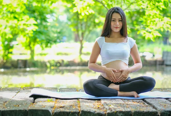 Happy pregnant asian woman with tablet pc at park — Stock Photo © Syda_Productions #175663478