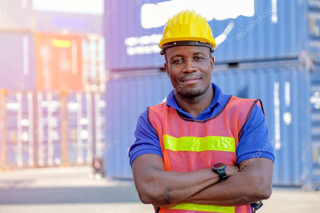 Technician man or worker in cargo container factory stand and action of confident with day light.