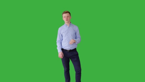 Man praten tegen een groene achtergrond — Stockvideo