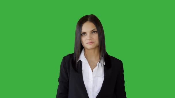 Businesswoman talking against green background — Stock Video