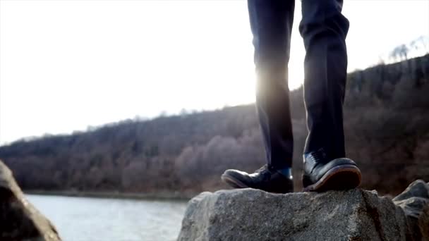 岩の上を歩いて 1 つの若い男 — ストック動画
