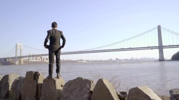 Man standing outdoors near the river — Stock Video