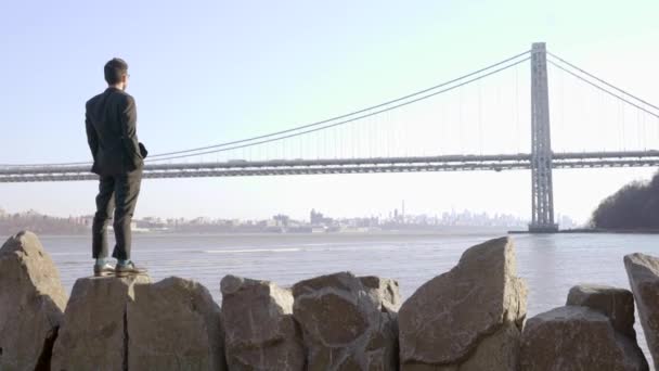 Man standing outdoors near the river — Stock Video