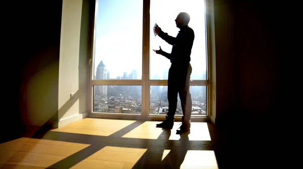 businessman near panoramic window with cityscape