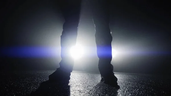 Person walking against car lights — Stock Photo, Image