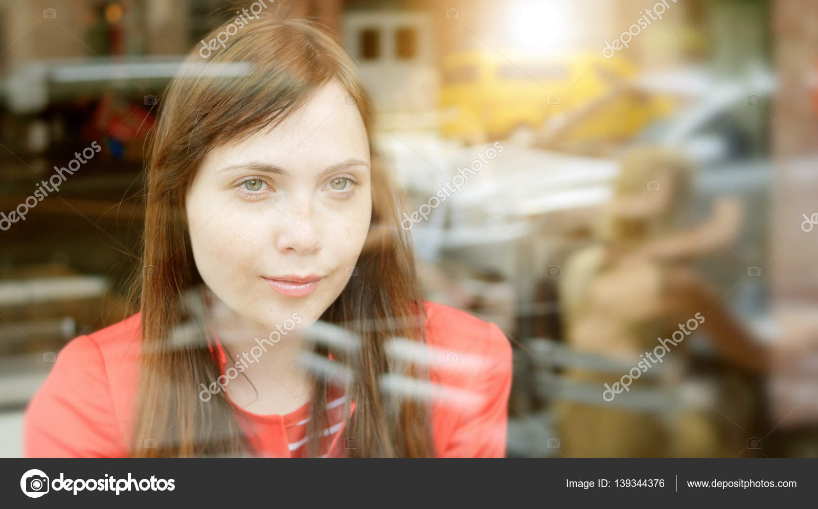 Woman behind glass window Stock Photo by ©stockmedia 139344376