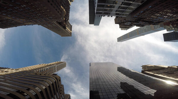 Bottom view shot of skyscrapers and blue sky