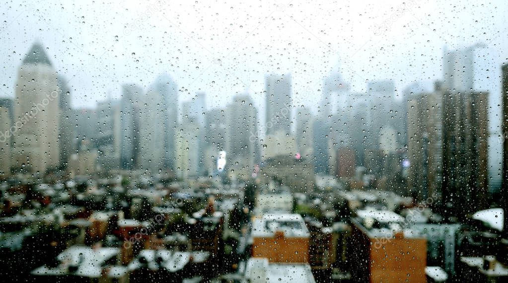 rain drops on window with blurred city