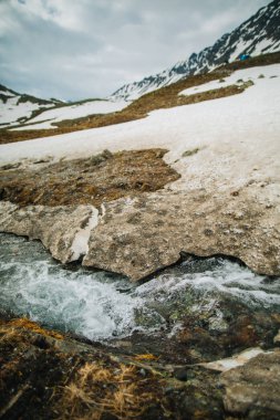 Bir nehir buz altında su detaylı bakmak çalışır. Kar eritme dağlar ve dere akar, kapat.