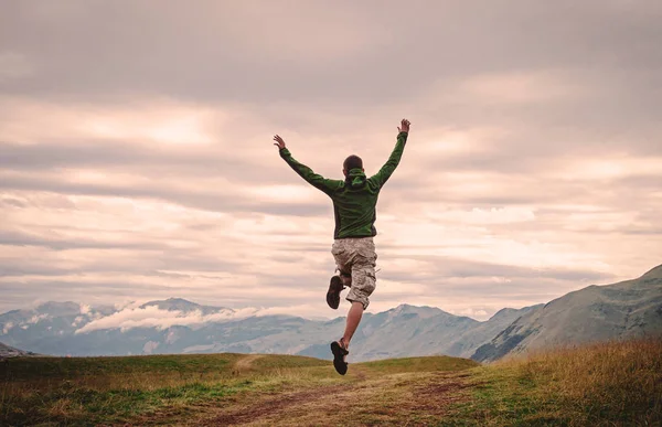 Young man jump in mountains — Stock Photo, Image