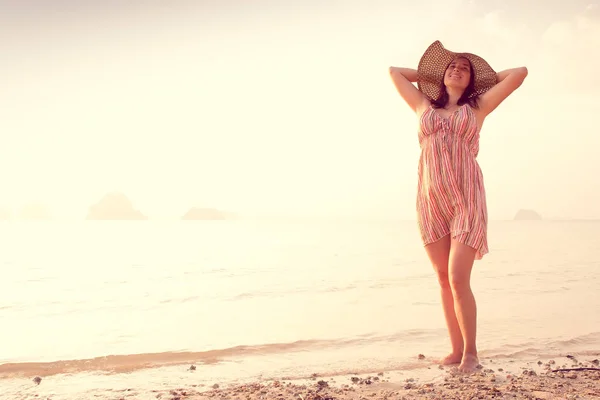 Happy Woman in a hat and short dress enjoys in Sea Sunset. In the background hilly karst mountains to the sea, vintage color — Stock Photo, Image