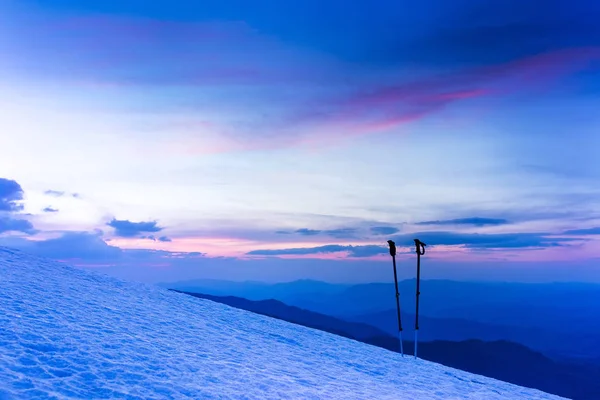 Lever de soleil d'hiver coloré dans les montagnes. Bâtons de ski ou bâtons de randonnée . — Photo