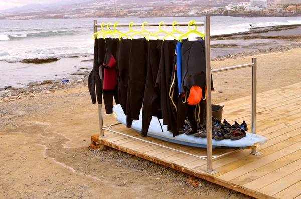 Playa De Las Americas beach wet suits — Stock Photo, Image