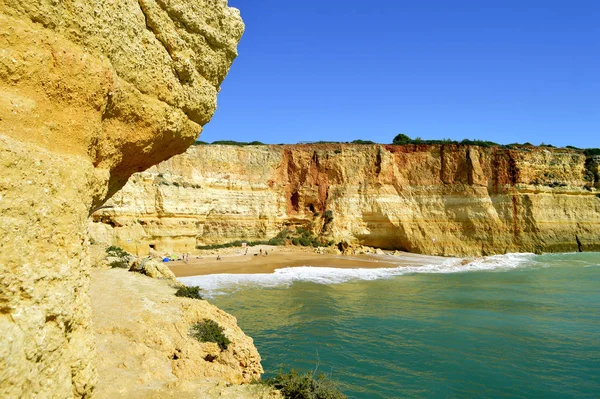 Benagil beach tourists on the beach — Stok fotoğraf