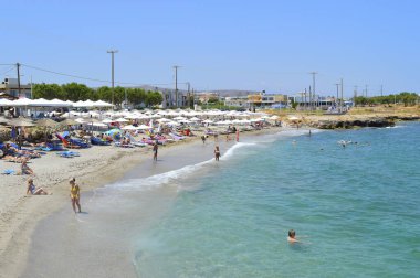 Kato Gouves, Girit, Yunanistan - 8 Haziran 2019: Girit 'teki Kato Gouves plajındaki turistler Yunan adalarının en büyük ve en kalabalık plajı