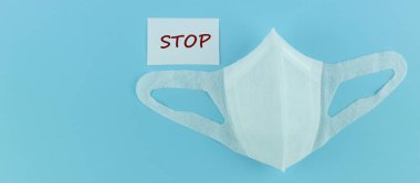 Protective face mask on blue background, against Novel coronavir