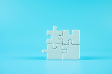 Mavi arkaplanda bulmaca parçaları ve metin için kopyalama alanı. Çözümler, misyon, başarılı, hedefler, işbirliği, ortaklık ve strateji kavramı