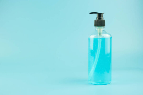 wash hand sanitizer gel bottle on blue background, against Novel coronavirus or Corona Virus Disease (Covid-19). Antiseptic, Hygiene and Healthcare concept