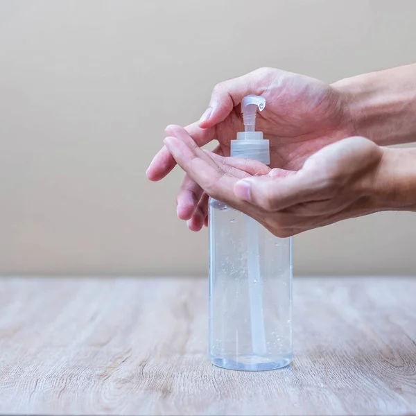 Man hands using wash hand alcohol gel or sanitizer bottle dispenser, against Novel coronavirus or Corona Virus Disease (Covid-19) . Antiseptic, Hygiene and Health concept