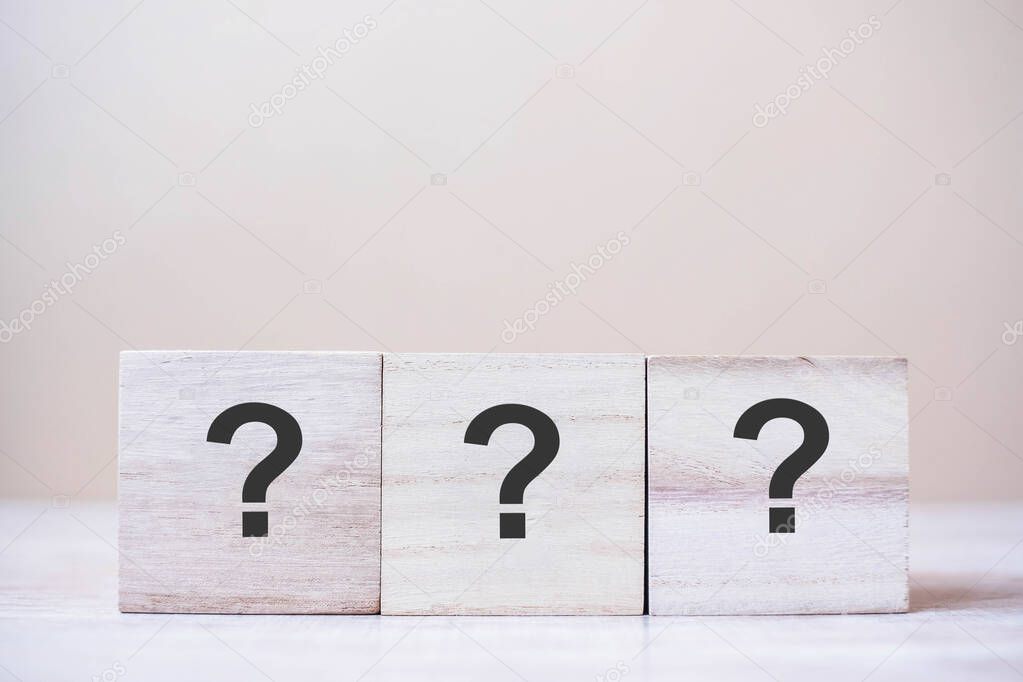 Questions Mark ( ? ) on wooden cube block on table background. FAQ( frequency asked questions), Answer, Q&A, Information, Communication and interrogation Concepts