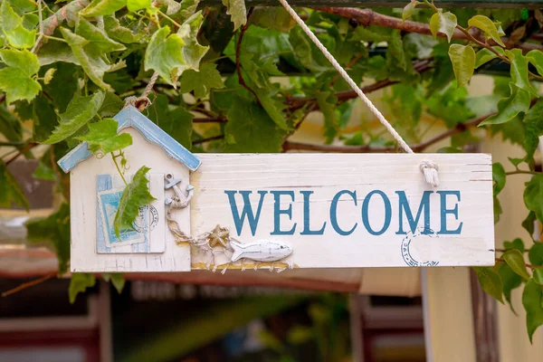 Welcome sign with a sea house shore theme. Vacational concept.