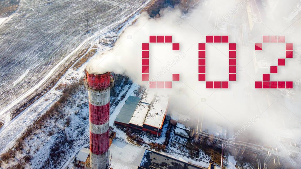 Smoking pipe with CO2 emissions at the industrial city zone from above.