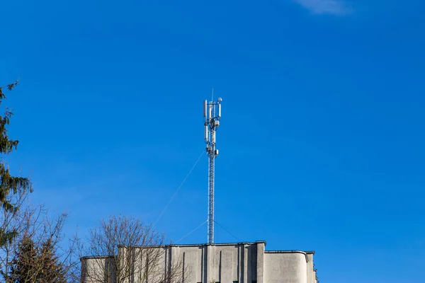 Telecommunications equipment - directional mobile phone antenna dishes on an extension tower. Wireless communication.