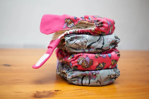 Stack of cloth diapers on a wooden table — Stock Photo, Image