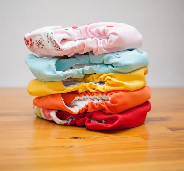 Stack of cloth diapers on a wooden table — Stock Photo, Image