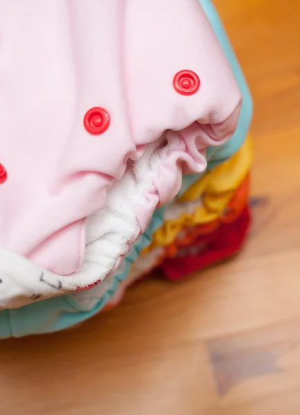 Stack of cloth diapers on a wooden table — Stock Photo, Image