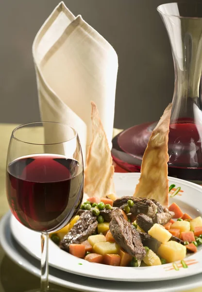 Delicious dinner arranged with a glass of red wine — Stock Photo, Image