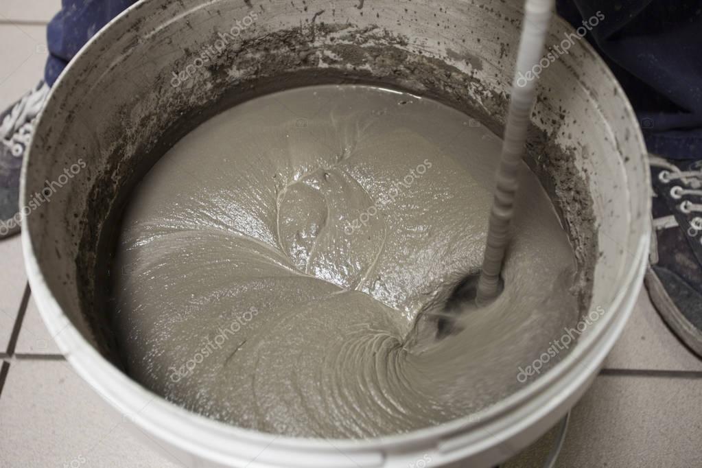 Mixing Tile adhesive with a power drill — Stock Photo © DimitarMitev