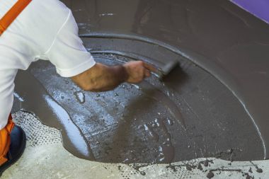 İşçinin şap beton zemin mala ile tesviye kendini koyar