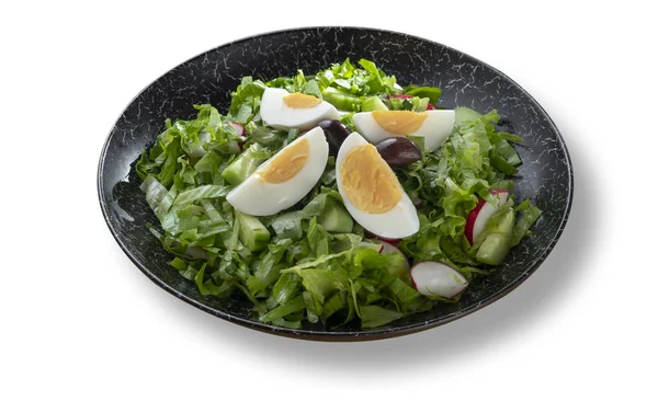 Fresh green salad with eggs in beautiful black modern plate — Stock Photo, Image