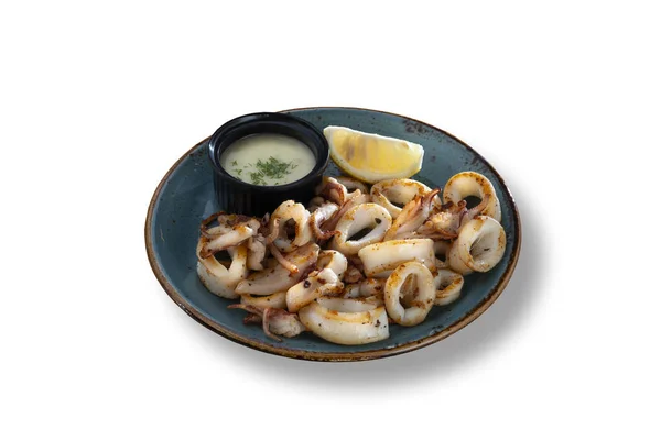 Fried calamari with lemon and dressing — Stock Photo, Image