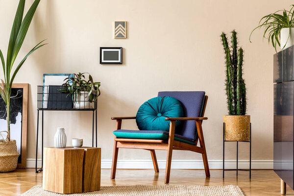 Interior design of retro modern living room with stylish blue navy commode, cacti in lastrico pot, design armchair with pillow, organizer and elegant personal accessories. Stylish home decor. Template