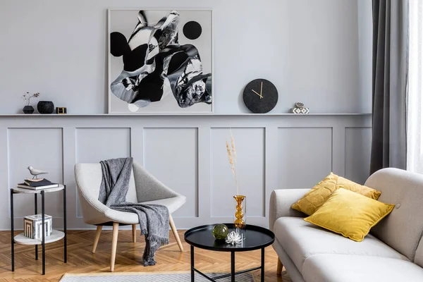 Modern scandinavian home interior of living room with design gray sofa, armchair, marble stool, black coffee table, stylish paintings, decoration and elegant personal accessories in home decor.