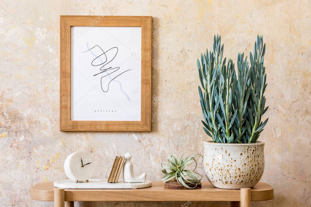 Modern interior of living room with design wooden console, plants, brown mock up poster frame, decoration and elegant personal accessories in wabi sabi home decor.